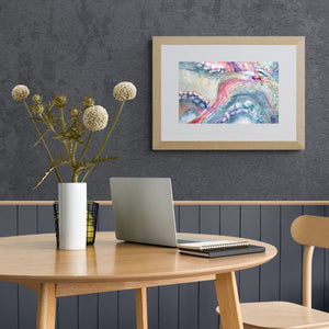 Framed octopus art print on the wall in scandinavian style dining room