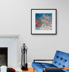 Comfy living room interior with fireplace, blue couch and reef art print on the wall