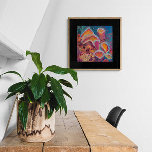 "Sponge Cluster" framed art print on wall above rustic office table and plant