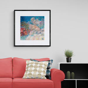 Modern living room with coral coloured comfy sofa and reef art print on the wall