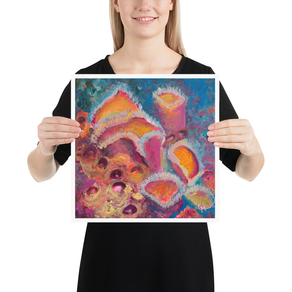 Woman holding colourful 14 by 14 inch art print with vibrant pink and orange sponges