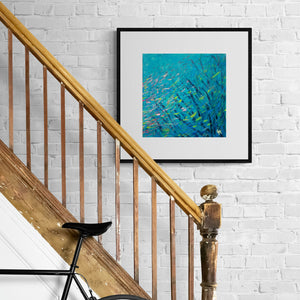 Framed turquoise blue print "Blennies in the Coral" beside hallway staircase with bike