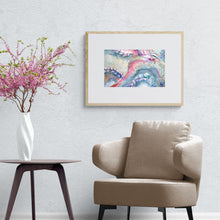 Load image into Gallery viewer, Modern armchair, side table and pink flowers below framed octopus art print on the wall