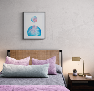Art print of underwater scene with jellyfish by Grace Marquez titled Bubble: Tentacles Reaching displayed on the wall  above the headboard in a cosy bedroom