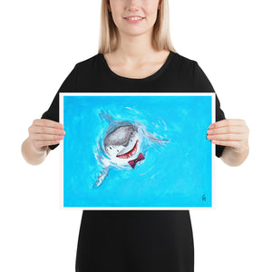 Woman holding a print illustration of a great white shark wearing a bowtie.